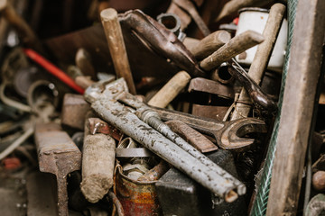 Old rusty tools lie in the shed
