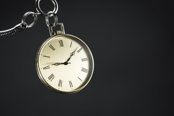 Close up of an old gold pocket watch. Beautiful antique watch isolated on black background.