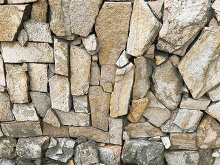 Background - a wall lined with a flat stone.