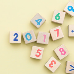 Wooden cubes with numbers on light green background