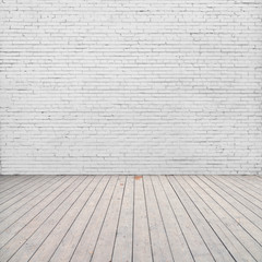 White brick wall and wood floor.