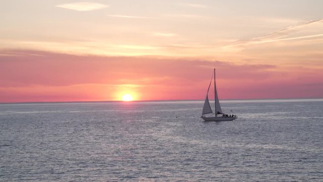 Boat passes sunset