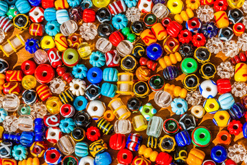 Fototapeta na wymiar Colorful beads on a wooden surface