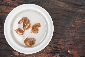Ground rice in white bowl on wood table,prepare cooking