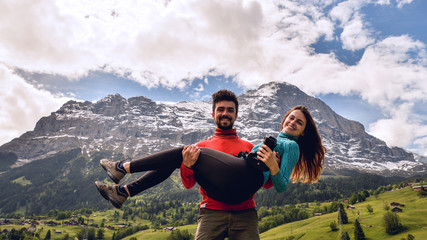 Couple having fun in the Alps. Beautiful landscape in the back. Switzerland