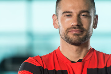 Muscular Man In Sports Outfit In Fitness Center