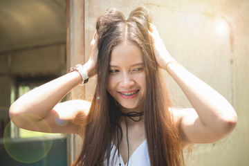 The lovely lady stood smiling and she make messy hair with len flare effect and bright...
