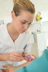 nurse taking a blood sample from patient