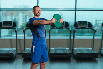 Fitness Man Doing Exercise For Shoulders With Weights