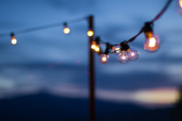 String of lights in a rocky mountain sunset