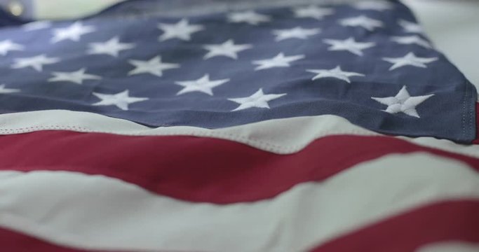 American flag detail with red and white stripes with field of blue and stars for 50 states. Shot in cinematic 4K.