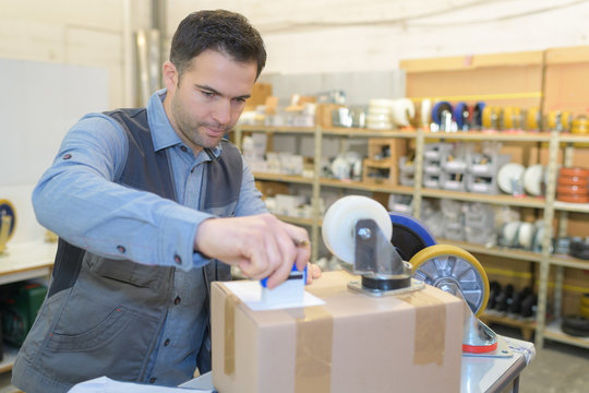 warehouse worker preparing a shipment in a large warehouse