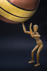 Basketball player/Person represented by a wooden dummy throwing a real size 7 basketball. - 160007084
