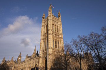 Fototapeta na wymiar England's Parliament building with deep blue skies rises above Westminster with a glimpse of the famous Big Ben