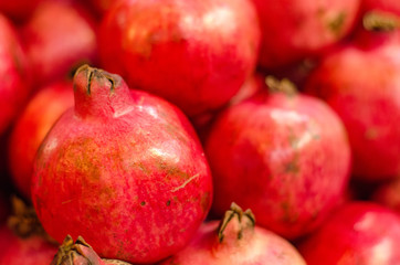Fresh raw pomegranates fruit on market stall in Malaysia.