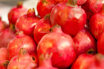 Fresh raw pomegranates fruit display on market stall in Malaysia