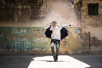 Naklejka na ściany i meble Hip hop dancer performing outdoors