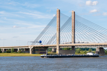 Tanker and Martinus Nijhoff Bridge, Waal river near Zaltbommel, Netherlands