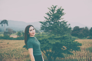 Closeup Beautiful thai woman in the field,rethink,think over,vintage style,dark tone,broken heart,asian girl