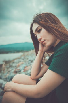 Beautiful thai woman very sad from unrequited love,rethink,think over,vintage style,dark tone,broken heart,asian girl