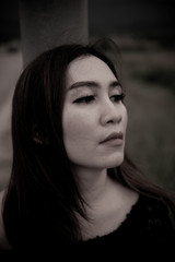 Beautiful thai woman very sad from unrequited love,rethink,think over,vintage style,dark tone,broken heart,asian girl