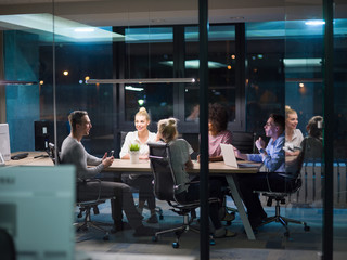 Multiethnic startup business team in night office