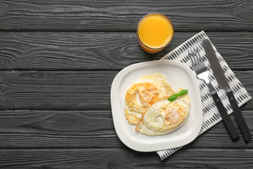 Plate with delicious over hard eggs on kitchen table