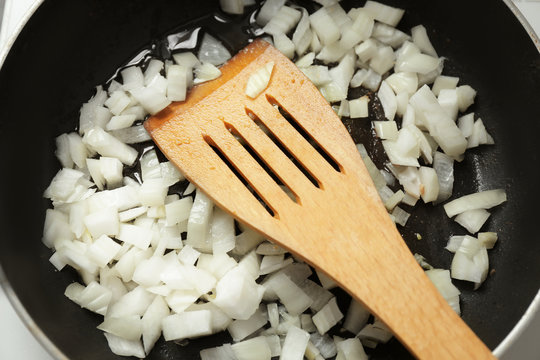 Frying pan with chopped onion, closeup