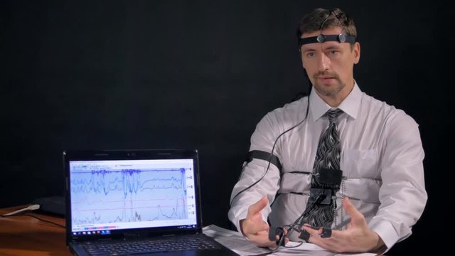 A man taking uneven breaths during polygraph test. 4K 60 fps.