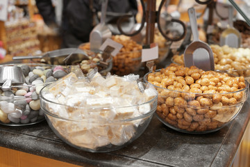 Bowls with delicious candies on table in shop