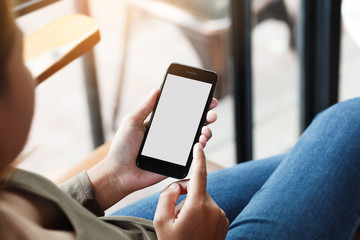 female using phone show white screen display in coffee shop outdoor lifestyle