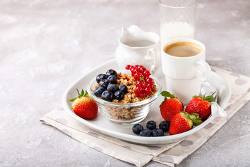 Breakfast - muesli, berries and coffee. Selective focus. Copy space