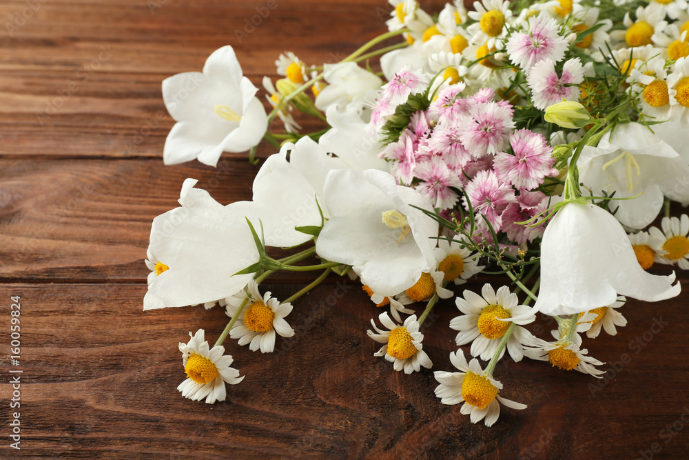 Sticker Beautiful meadow flowers on wooden background