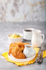 Breakfast - croissant, egg and coffee. Selective focus. Copy space