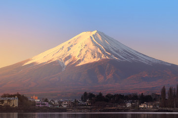 Morning sunlight at the peak of Mount Fuji on a bright sky day and the city around kawaguchi lake in japan. This is a very popular for photographers and tourists. Travel and natural Concept