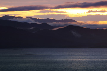 Natural background of colorful sky and mountain during sunset at Kaeng Krachan Dam, Kaengkrachan National Park ,Petcahburi  in Thailand. Attractions and natural Concept.