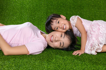 Asian Chinese mother and daughter looking at camera and smiling