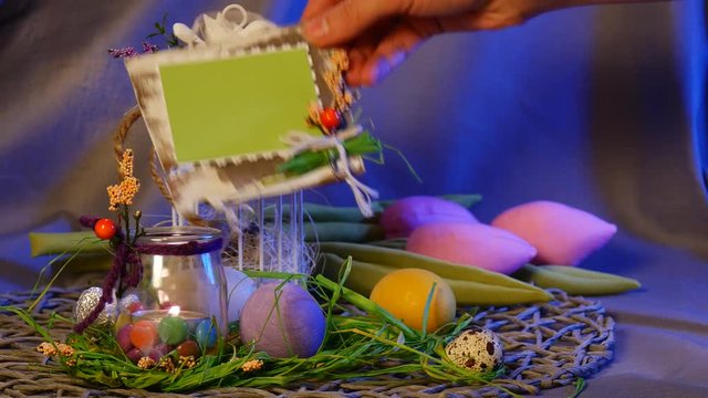 Easter Hen and Quail Eggs Are Put Near a Top Egg Cage, as Well as a Festive Photo Frame, Near a Bunch of Rosy Tulips