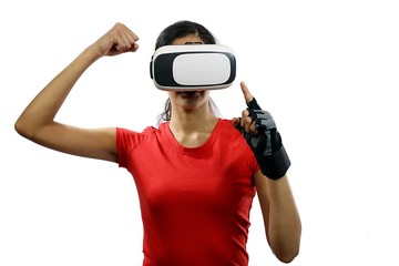 Young attractive woman wearing virtual reality goggles and remote control glove