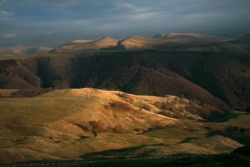 landscape of the yellow mountains in the evening at sunset with blue sky and clouds