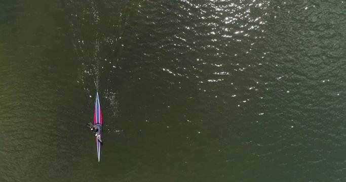Kayak Aerial Shot Looking Straight Down as Man Paddles Fast Sparkling Green Water on a Sunny Day