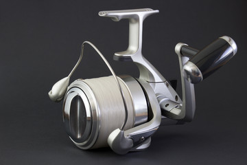 fishing reel isolated black background