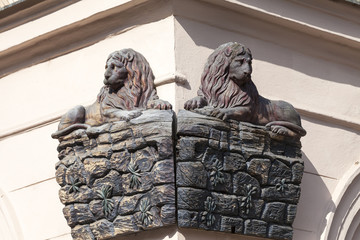 Relief on facade of old building, wooden lion , Prague, Czech Republic