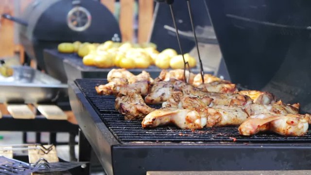 Barbecue With Delicious Grilled Meat On Grill. Barbecue Party. Chicken meat pieces being fried on charcoal grill .Cooking delicious juicy meat steaks on the grill on fire.
