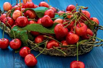 cherries on a dark wood background. selective focus on cherry in the bowl