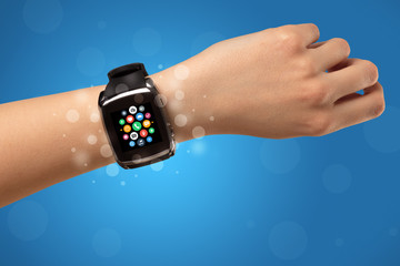 Female hand with smartwatch and app icons