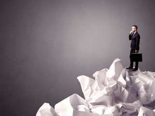 Businessman standing on crumpled paper