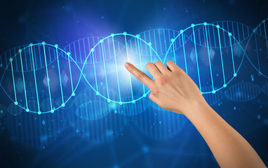 Hand touching DNA molecule