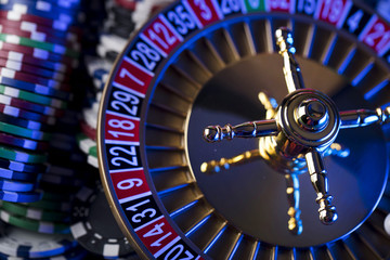 Casino blurred background. Roulette and stacks of chips.