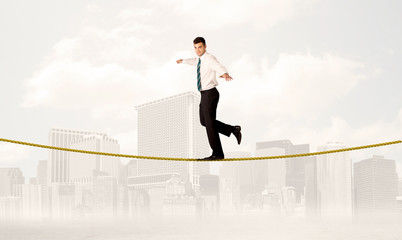 Business person balancing on golden rope